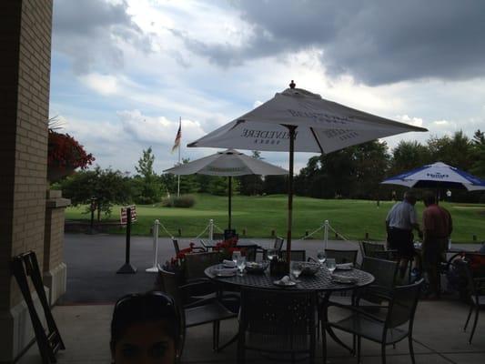 A view of the golf course sitting outside.