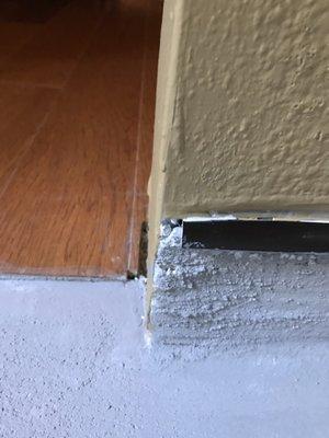 The oil rubbed bronze tile trim was not cut to the full length of the wall by the first stucco guy. (very rough finish by first stucco guy)