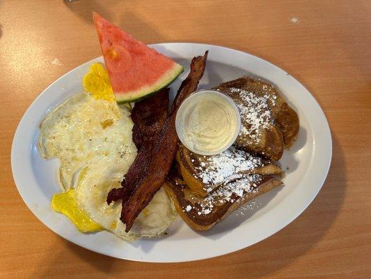 1/2 portion French toast with fried eggs and bacon