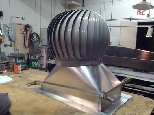 Elevator shaft ventilator in office building to sloped roof.