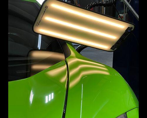 Mclaren in the shop for dent repair.