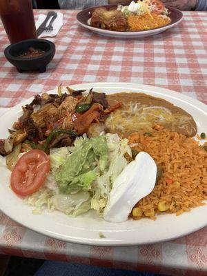 Two Beef, chicken, shrimp flower tocos with sour cream lettuce ,avocado topping. Refried beans and yummy rice.