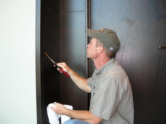 Professional craftsman doing a 'burn-in' process which fills large gouges.