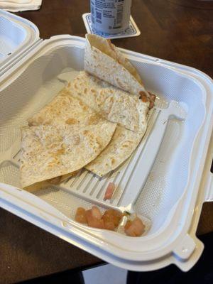 a sad quesadilla "grande" with tomato garnish.