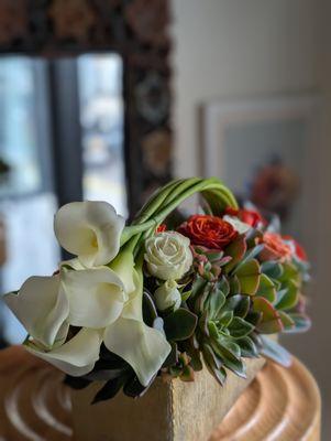 Modern succulent and rose arrangement in a golden vase -- available for same-day succulent delivery from your florist near me.