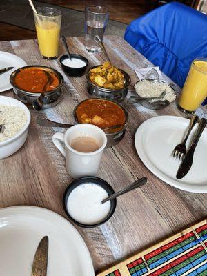 Mango lassi, hot chai latte, aloo gobi, chicken vindaloo, butter chicken makhani, rice, raita. All delicious at India Garden!