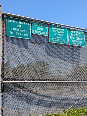 Signs around the tennis courts