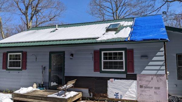 Still tarped weeks later.