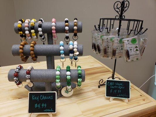 Handmade keychains and CBD vape cartridges.