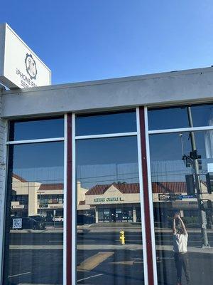 Our IPhone Repair Services Sign At Local Shop.