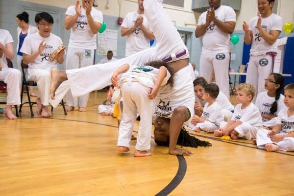 Parent bounding Capoeira Roda