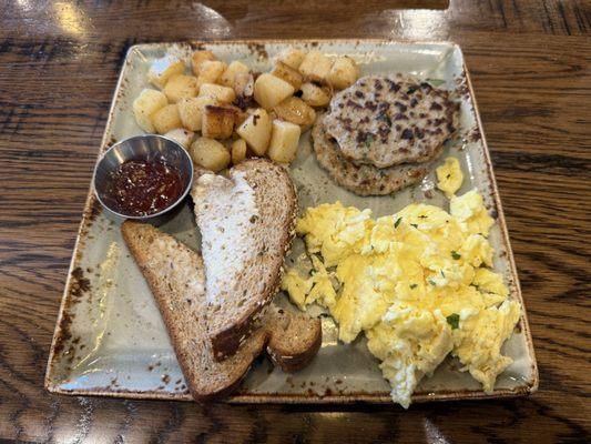 Traditional breakfast: Scrambled eggs, chicken sausage patties, potatoes and wheat toast.