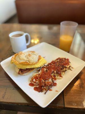 Breakfast sammie with scrambled and Hana on on a biscuit. Hash on the side