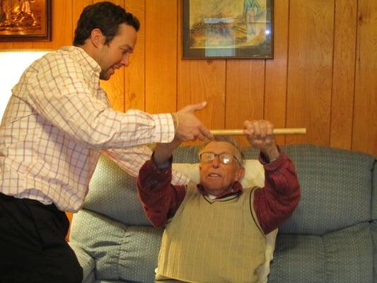 Dr. Warner performing a strengthening technique in the patient's home.