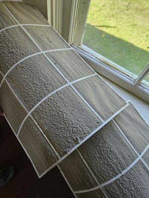 Filter completely covered with at least 1/2" of dust, grime.