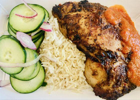 Peri-peri chicken with garlic rice and freshly-picked cucumbers.