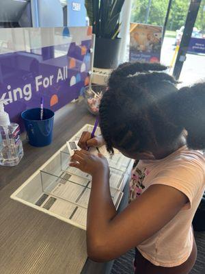 Filling out her bank slip