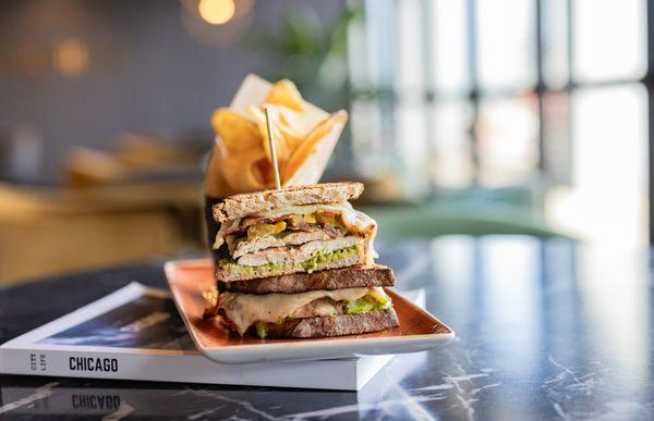 Our Chicken Club is buttermilk fried, thick cut bacon, havarti cheese, heirloom tomatoes, green goddess dressing all on toasted sourdough