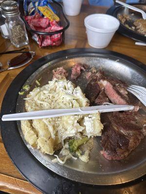 Potato with mozzarella cheese and plastic utensils