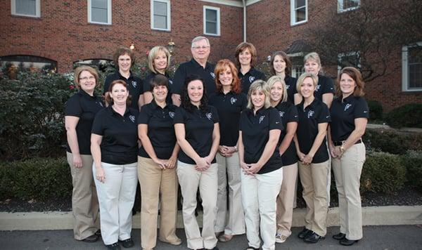 The Hull & Appel staff outside the brick office building their suite is found in.