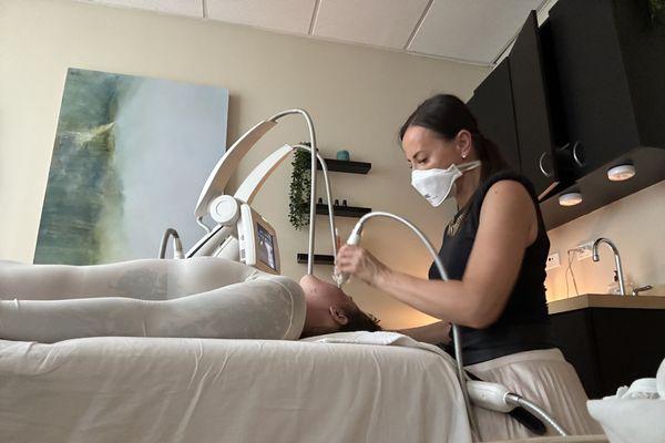 Inga performing a face treatment on me.