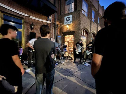 One of the bands at Drop to Pop performing at night/late evening.