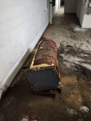 Basement where laundry is offered for apartments without washers and dryers Old rusty boiler for over a year left here