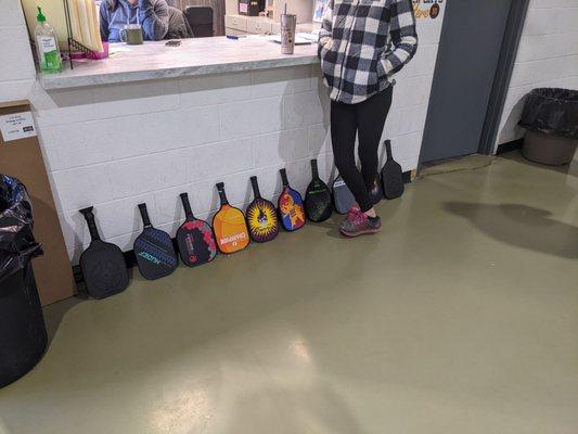Photo of players paddles queued and waiting for an open court.