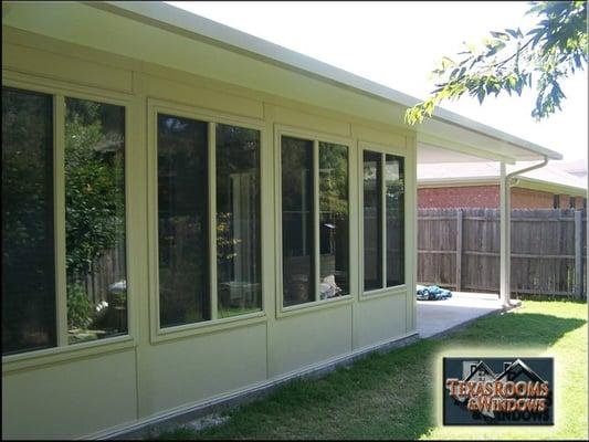 Sunroom with extended roof and insulated patio cover.