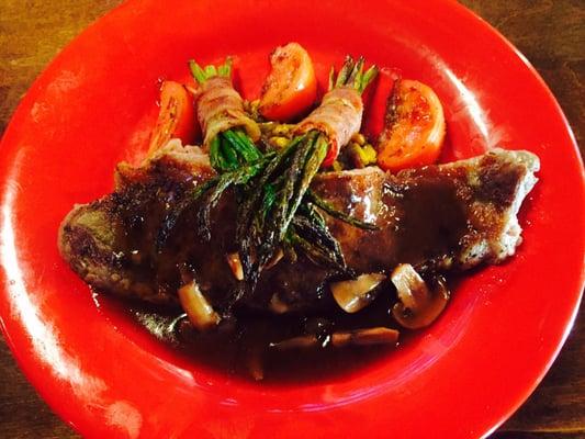 N.Y. Strip with a mushroom Demi-glaze over sweet southern style corn and bacon wrapped asparagus!