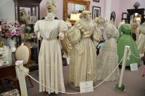 Display of Victorian bridal gowns on the left side of the shop
