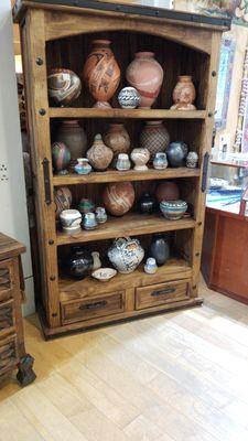 Rustic bookshelf with pottery