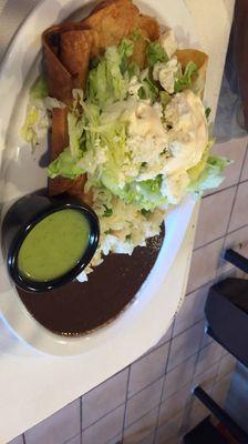 Taquitos. Crispy and delicious. Topped with fresh lettuce and cheese and creama.