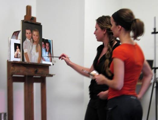 Instructor Brianna Lee helps a student on her portrait commission