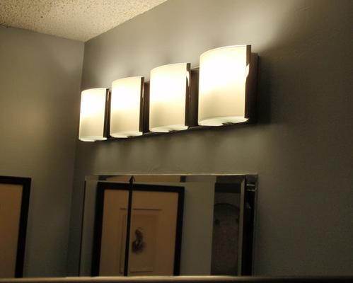 Bathroom: Muted yet bright lighting over vanity mirror provides sufficient light without the glare