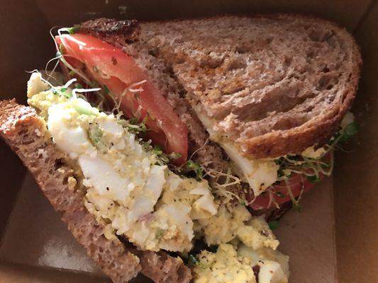 Egg Salad sandwich with tomato & sprouts on wheat.