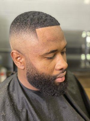 High bald fade with beard shaping and razor line