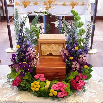 Funeral arrangement for a Cremation Urn. Call shop for prices.