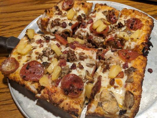 Sausage, pepperoni, pineapple and mushroom pizza.
