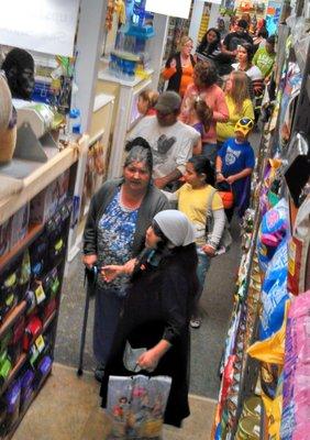 Trick or Treaters line up to meet the gorilla