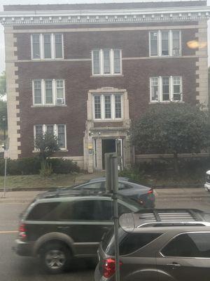 Apartment building with door propped open.