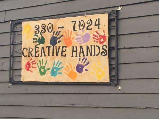 Outside sign on the side of the shop.