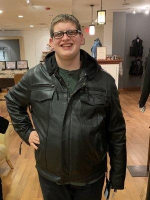 My son proudly wearing his new leather jacket.