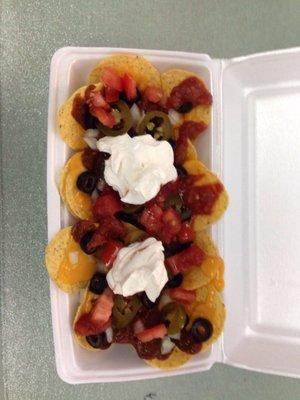 Love the nacho Bar  Cheese, chili, sliced olives, salsa, jalapeños, sour cream, fresh diced tomato. Everything you need to load em up