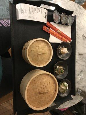 The spread. Bao is in the big bamboo container; potstickers are in the smaller one.