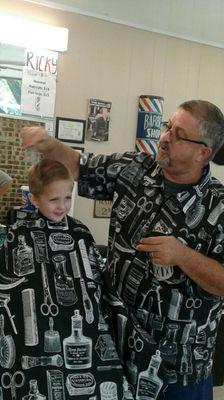 I'm cutting my best customer, my three year old Grandson Bryson.