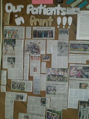 Bulletin board of some his patients. From newspaper clippings and photos.