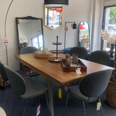 Our newest dining table paired with grey velvet chairs.