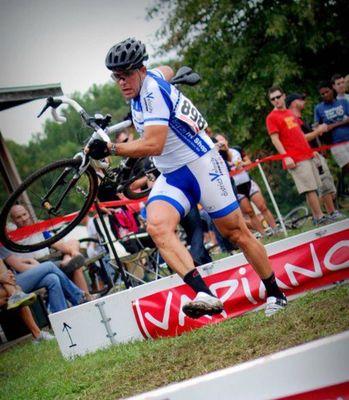 Byron carries his bike in a foot race, just because.