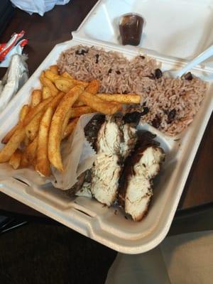 Jerk chicken breast, beans & rice, and seasoned fries.